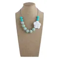 Silicone baby teething necklace featuring mint beads and a white rose flower pendant - Necklace / Light Green