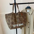 Leopard print canvas tote bag with large TOTE BAG lettering and sturdy handles - Brown