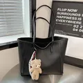 Black pebbled leather tote bag with cute bear charm and red checkered ribbon detail - Black