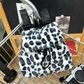 Faux rabbit fur leopard print backpack with drawstring closure and black nylon straps - Black and Grey Leopard Style (Style 1)