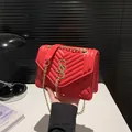 Red quilted leather crossbody bag with gold chain strap and elegant tassel detail - Red