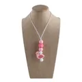 Pink flamingo baby teething pendant on silicone bead necklace shown on a jewelry bust - Flamingo