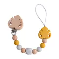 Handmade baby pacifier clip with yellow silicone leaf and natural beech wood beads - Turmeric