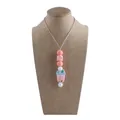 Pink bubble tea silicone teething necklace with soft chewable beads on a grey cord - Milk Tea Cup