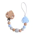 Silicone and beech wood pacifier clip with light blue monstera leaf and geometric beads - Blue