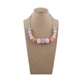 Silicone teething necklace for babies with pink and grey geometric beads on neck model - Pink