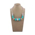 Silicone teething necklace for babies with mint green and grey beads on a neck display - Lake Blue