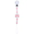 Pink and white silicone baby pacifier clip with a bow decoration on a white background - Pink