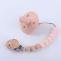 Close-up of pink food-grade silicone pacifier with natural wood and silicone bead clip chain - Light Pink