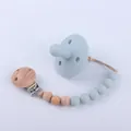 Detail of light blue silicone baby pacifier and wooden clip pacifier chain set - Gray Blue