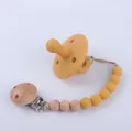 Mustard yellow silicone baby pacifier with a matching beaded wooden clip chain - Turmeric