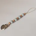 Detail of baby pacifier clip with wood beads, blue silicone beads and metal clasp - Grey Blue