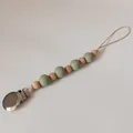 Detailed view of silicone beads and wooden beads on a sage green pacifier clip - Sage Green