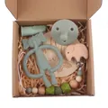Close-up of baby gift set with silicone elephant teether and wooden pacifier clip - Sage Green Elephant