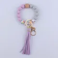 Detail of beaded silicone wristlet keychain with purple leather tassel and metal clasp - Light Purple
