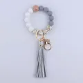 Detail of leopard print silicone beads and grey PU leather tassel on a key ring - Silver