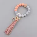 Close-up of silicone beads, hexagonal wood bead, and pink PU leather tassel keychain - Flesh Pink
