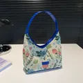 Retro floral woven tote bag in cream fabric with bright blue leather handles and trim - Blue