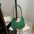 Green crescent shoulder bag with crocodile pattern texture and golden zipper closure - Green