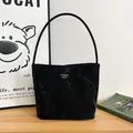 Sac à main plissé noir élégant avec logo triangulaire et bandoulière minimaliste - Noir