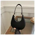 Minimalist black crescent shoulder bag with stone texture and gold metal buckle accents - Black