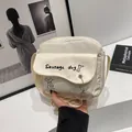 Close-up of cream canvas crossbody bag with cute sausage dog print and cloud pendant detail - White