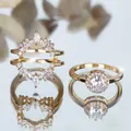 Macro shot of 18K gold plated silver stacking halo ring with cluster stones and crown enhancer - US 6 / Gold with White Stone