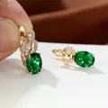 Vista macro degli orecchini con pietra verde ovale e finitura in oro champagne e zirconi - Verde