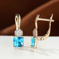 Elegant champagne gold leverback earrings with blue sapphire square stones and floral accents - Light Blue