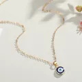 Elegant gold evil eye pendant necklace with blue enamel charm on minimalist chain - Blue & Pink