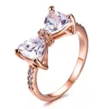 Elegant rose gold bow ring featuring sparkling triangular zircon stones and micro-pave accents - US 7 / Rose Gold/White Zirconia