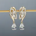 Elegant champagne gold drop earrings featuring pear-cut pink crystals and diamond accents - Champagne Gold White Stone