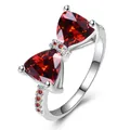 Elegante zilveren strikring met rode driehoekige edelstenen en zirkonia accenten - Geplatineerd Rode Zirkonia