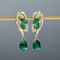 Champagne gold drop earrings featuring marquise and pear-cut emerald green crystals - Champagne Gold Green Stone