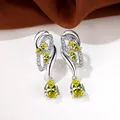 Elegant silver earrings with pale yellow teardrop crystals and sparkling stone accents - White Gold With Yellow Zircon