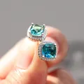 Macro shot of cushion-cut teal tourmaline halo stud earrings with micro-pave diamond accents - Silver-Tone Blue Green