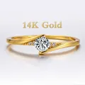Elegant 14K yellow gold bypass ring featuring a round brilliant-cut center stone and accents - US 4 / Gold