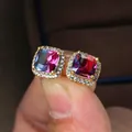 Macro detail of square princess-cut earrings with bicolor gradient stones and gold plating - Gold-Tone Pink Blue