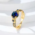 Anillo floral en oro rosa con gema ovalada azul zafiro y detalle de banda dividida - Talla 5 / Oro Azul Real