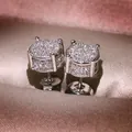 Macro shot of micro-paved silver stud earrings with sparkling round cubic zirconia - White Gold With White Zirconia