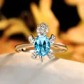 Creative silver sea turtle ring featuring a large oval blue gemstone and micro-pave diamonds - Size 6 / Aqua Blue Zirconia