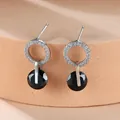 Detailed view of silver hoop earrings with white zircon pavé and black round crystal drop - Platinum Plated Black Zirconia