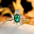 Elegant silver turtle ring featuring an oval emerald green stone and white zircon accents - Size 6 / Green Zirconia