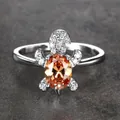 Silver sea turtle ring with a large oval orange gemstone and white crystals - Size 6 / Champagne Zirconia