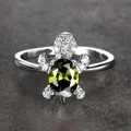 Polished silver turtle ring with a large green oval gem and micro-paved white stones - Size 6 / Olive Green Zircon