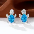 Orecchini a perno tartaruga in argento con opale blu e zirconi scintillanti - Opale Blu Platino