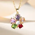 Elegant gold flower necklace with colorful rhinestones on a soft beige fabric background - Colorful Flower Necklace