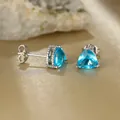 Elegant twisted silver stud earrings with triangle cut sky blue sapphire gemstones - Platinum Plated Aqua Blue