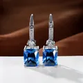 Silver drop earrings featuring emerald-cut dark blue sapphire with tiny cubic zirconia accents - White Gold Plated Royal Blue