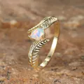 Detailed close-up of golden feather ring band featuring a teardrop-shaped opal stone - US 6 / Gold White Opal